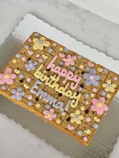 a birthday cake decorated with flowers and butterflies