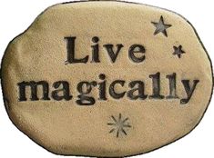 a rock with the words live magically written in black ink on it and stars