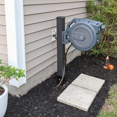 a blower sitting on the ground next to a house