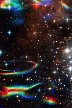 an image of the sky with stars and rainbows
