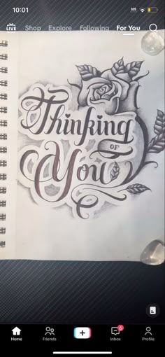 an open notebook with the words thinking and you written in cursive writing on it