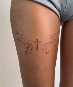 the back of a woman's thigh with tattoos on it