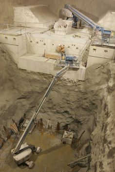 an aerial view of a construction site in the desert, with workers working on it