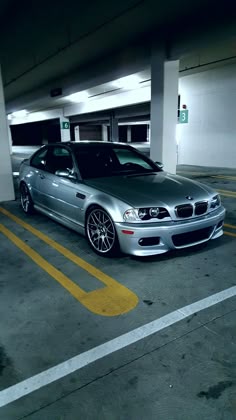a silver car parked in a parking garage