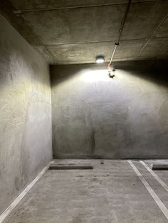 an empty parking garage with concrete walls and floor