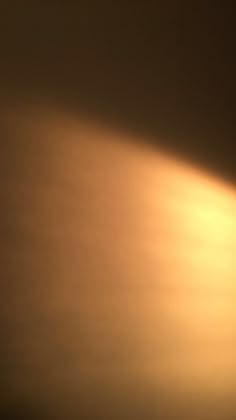 an airplane is flying in the sky with light coming from it's back end