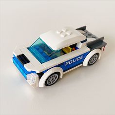a lego police car is shown on a white surface