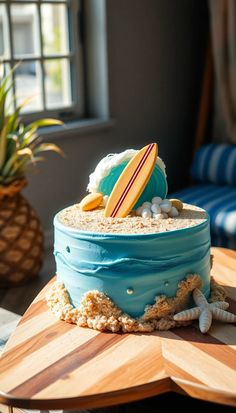 a surfboard and starfish cake sitting on top of a wooden table next to a potted plant