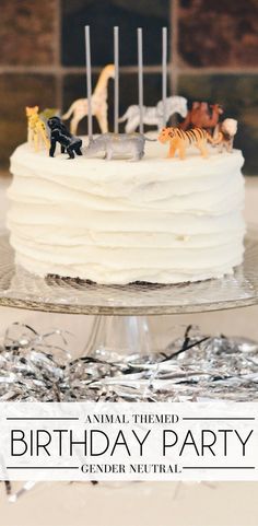 a birthday cake with toy animals on top
