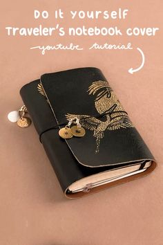 a black notebook with two gold buttons attached to it and a note book cover that says do it yourself traveler's notebook cover
