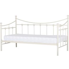 a white metal bed frame with a mattress on it's side and headboard
