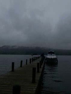 a boat is docked at the end of a pier