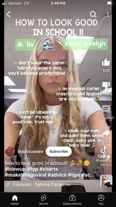 a woman with long blonde hair sitting in front of a computer screen and looking at the camera