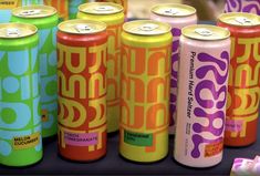 several cans of soda are lined up on a table