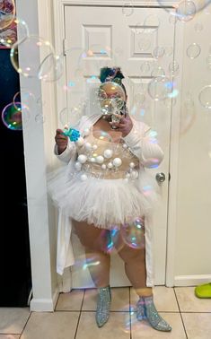 a woman is standing in front of a door with bubbles all over her face and body