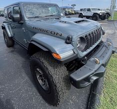 a gray jeep parked in a parking lot