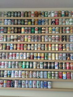 a shelf filled with lots of different types of beer cans
