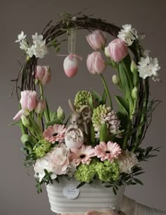 a person holding a basket with flowers in it