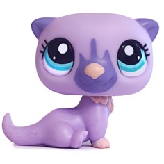 a close up of a purple cat figurine on a white background with blue eyes