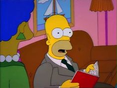 the simpsons is reading a book in his living room