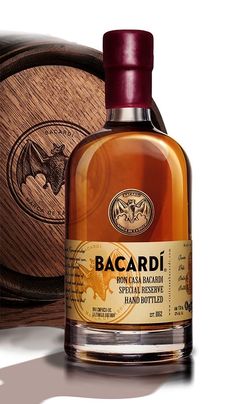 a bottle of bacardi with a wooden box behind it