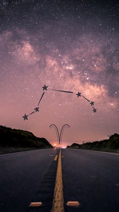 an empty road with stars in the sky