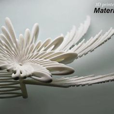 an intricately designed white flower is shown on the surface with text that reads 3d printer materials material