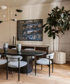 a dining room table surrounded by white chairs
