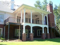 a large white house sitting on top of a lush green field