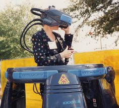 a woman standing in the back of a blue truck