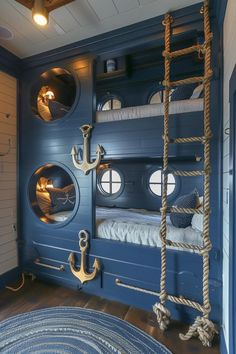 a bunk bed in a room with blue walls and rope ladders on the wall