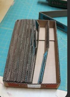 an open box sitting on top of a table next to some scissors and paper cutters