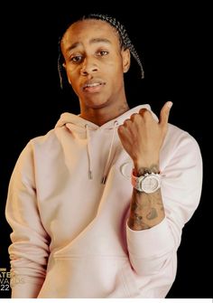 a man in a white hoodie is holding his hand up