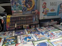 nintendo wii games are on display in a store with other video games and game accessories