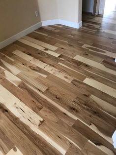 an empty room with hard wood flooring in it