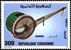a postage stamp with an image of a musical instrument in arabic writing on the front