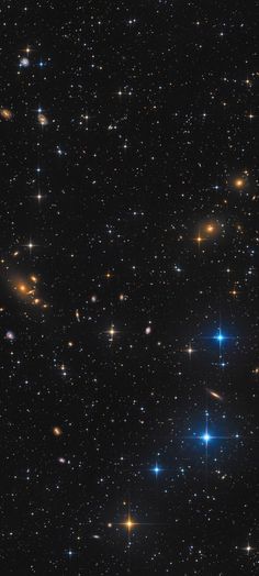 many stars in the night sky with bright blue and yellow lights on it's sides