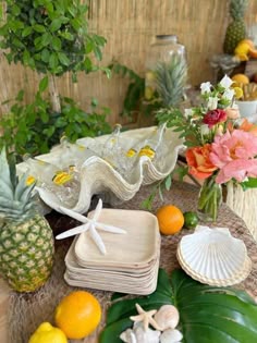 a table topped with plates and vases filled with flowers