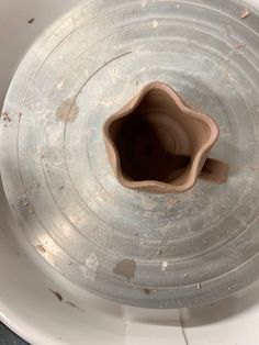 an empty vase sitting on top of a white table