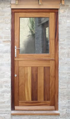 a close up of a wooden door on a brick building