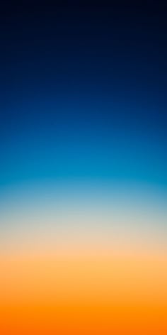 an airplane is flying in the sky at sunset or sunrise with orange and blue hues