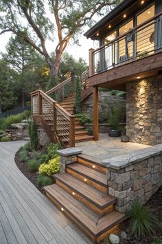 a wooden deck with steps leading up to a stone building and stairs that lead down to the second floor