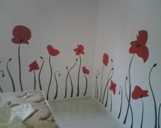 a bedroom with red flowers painted on the wall
