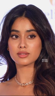 an image of a woman with long hair wearing a choker and necklace on her neck