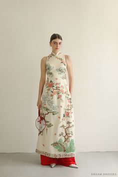 Detail: The dress: Color of the dress: cream ivory Fully custom designed embroidery Mandarin collar Collar: 1.5''/4cm Illusion back Side closing with buttons Red pants Made to order The cape: High fashion bridal cape Color: cream ivory Fully custom designed embroidery Chapel length: 2.2 meters (86 in) Picture shown in chapel length Made to order Fitted Floral Embroidered Ao Dai For Wedding, Embroidered Ao Dai For Spring Formal, Fitted Long Embroidered Ao Dai, Ceremonial Fitted Embroidered Ao Dai, Summer Wedding Ao Dai With Floral Print, Traditional Ao Dai With Floral Embroidery For Ceremony, Traditional Fitted Embroidered Ao Dai, Elegant Embroidered Fitted Ao Dai, Luxury Fitted Ao Dai With Floral Embroidery