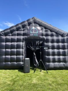 an inflatable stage set up on the grass with a microphone and sound system