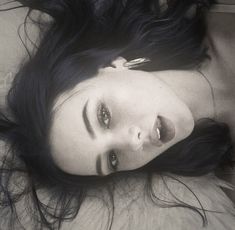 a black and white photo of a woman laying down