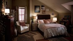 a bed room with a neatly made bed and a chair