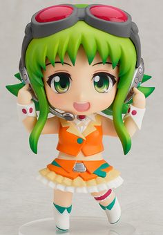 a doll with green hair and red eyes holding a pair of headphones in her hands