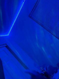 a room with blue lighting and a bed